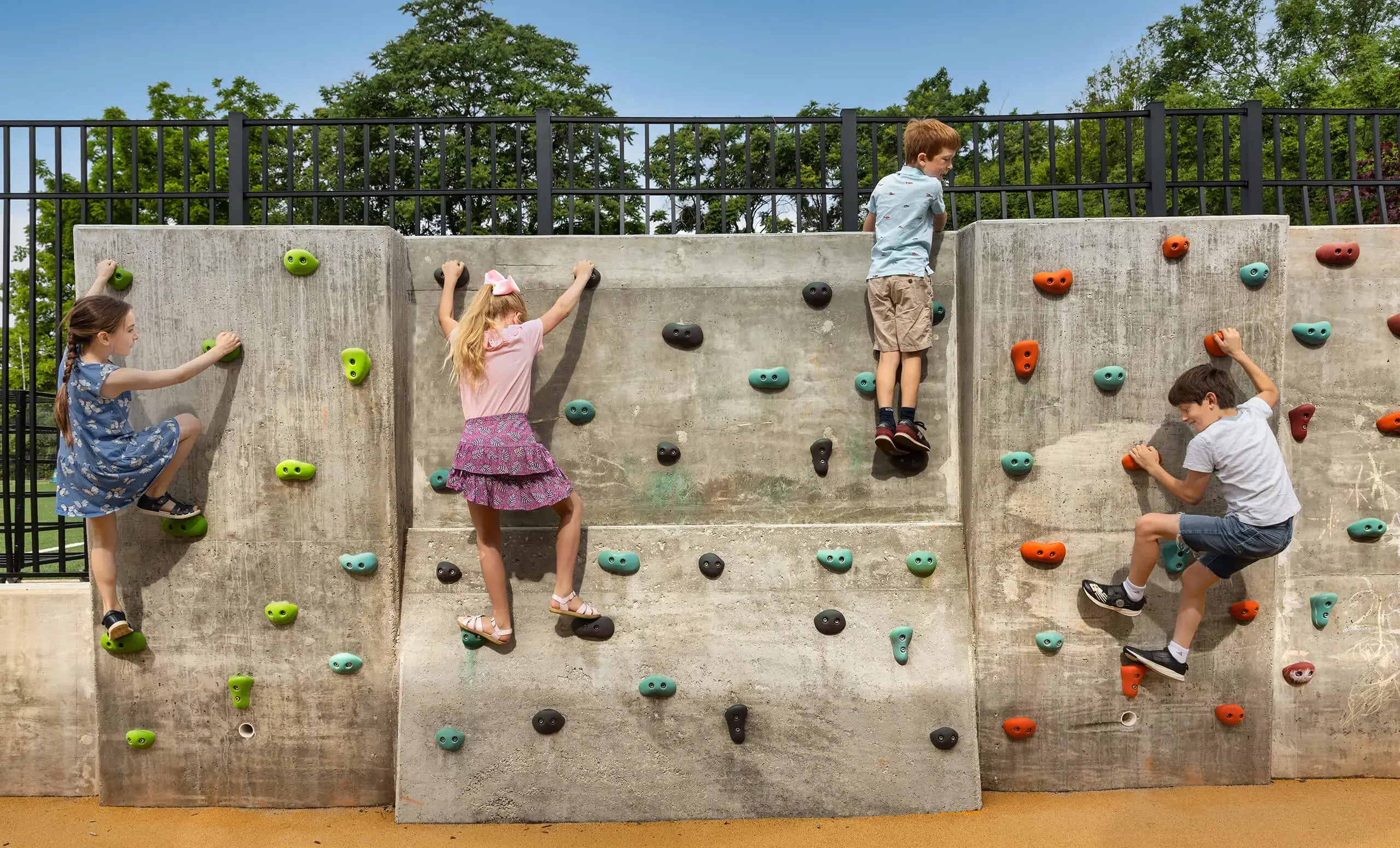 four children on a small climbing wall