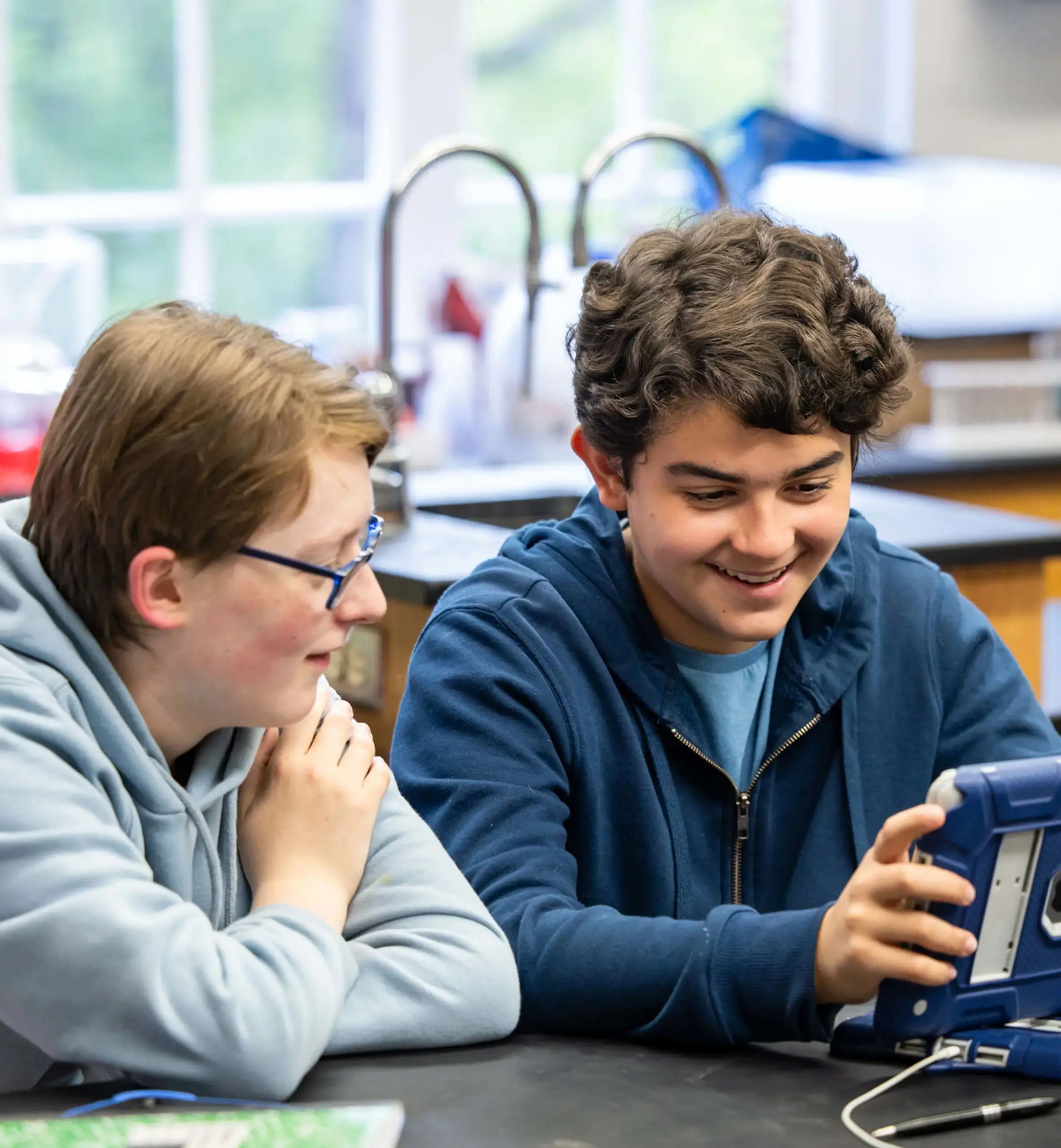 Two boys studying with an iPad