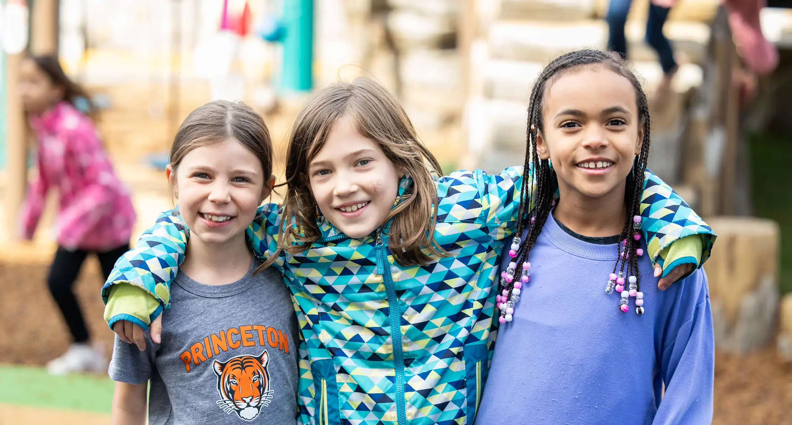 three friendly girls on the playground