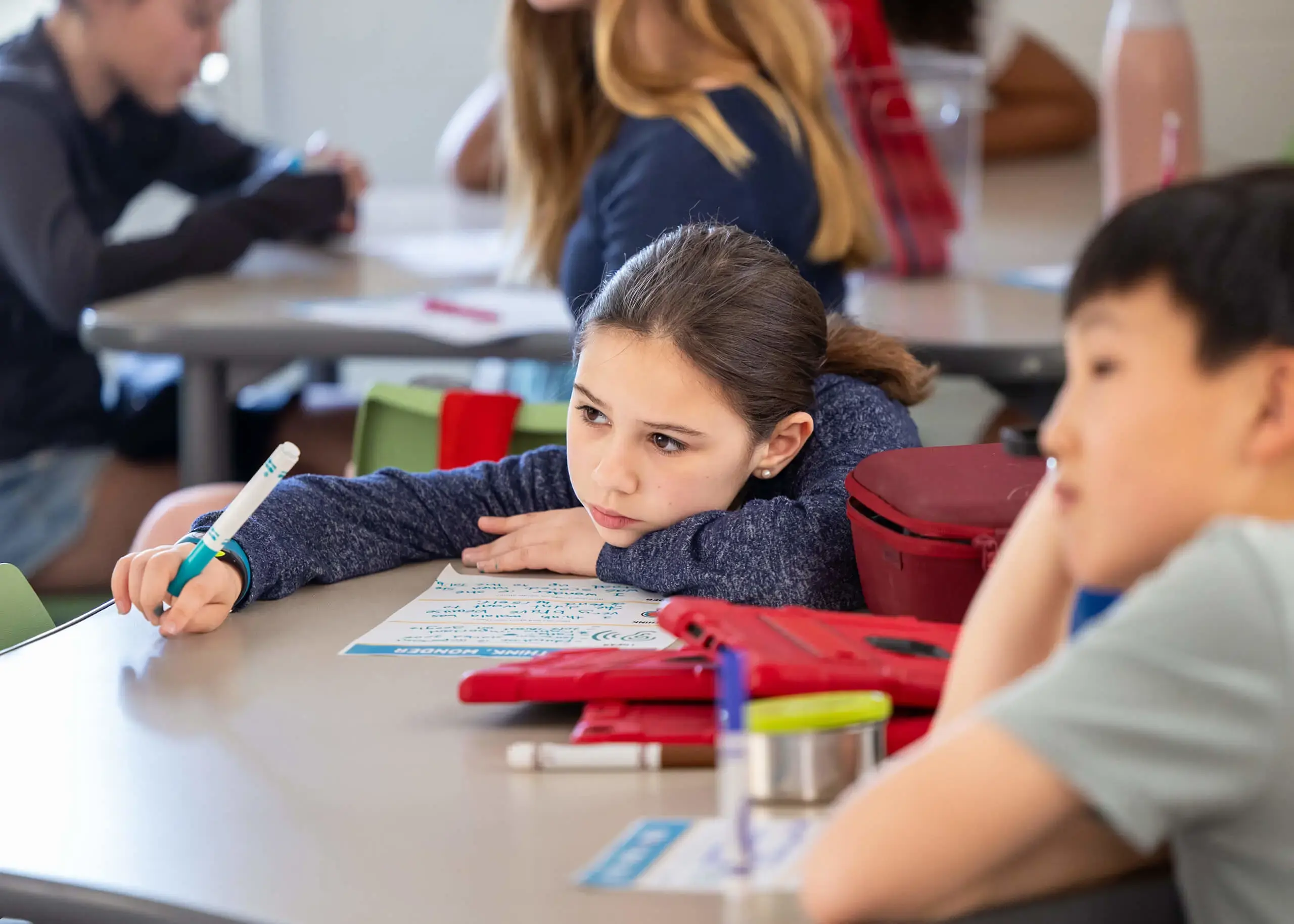 wistful girl holding a pen