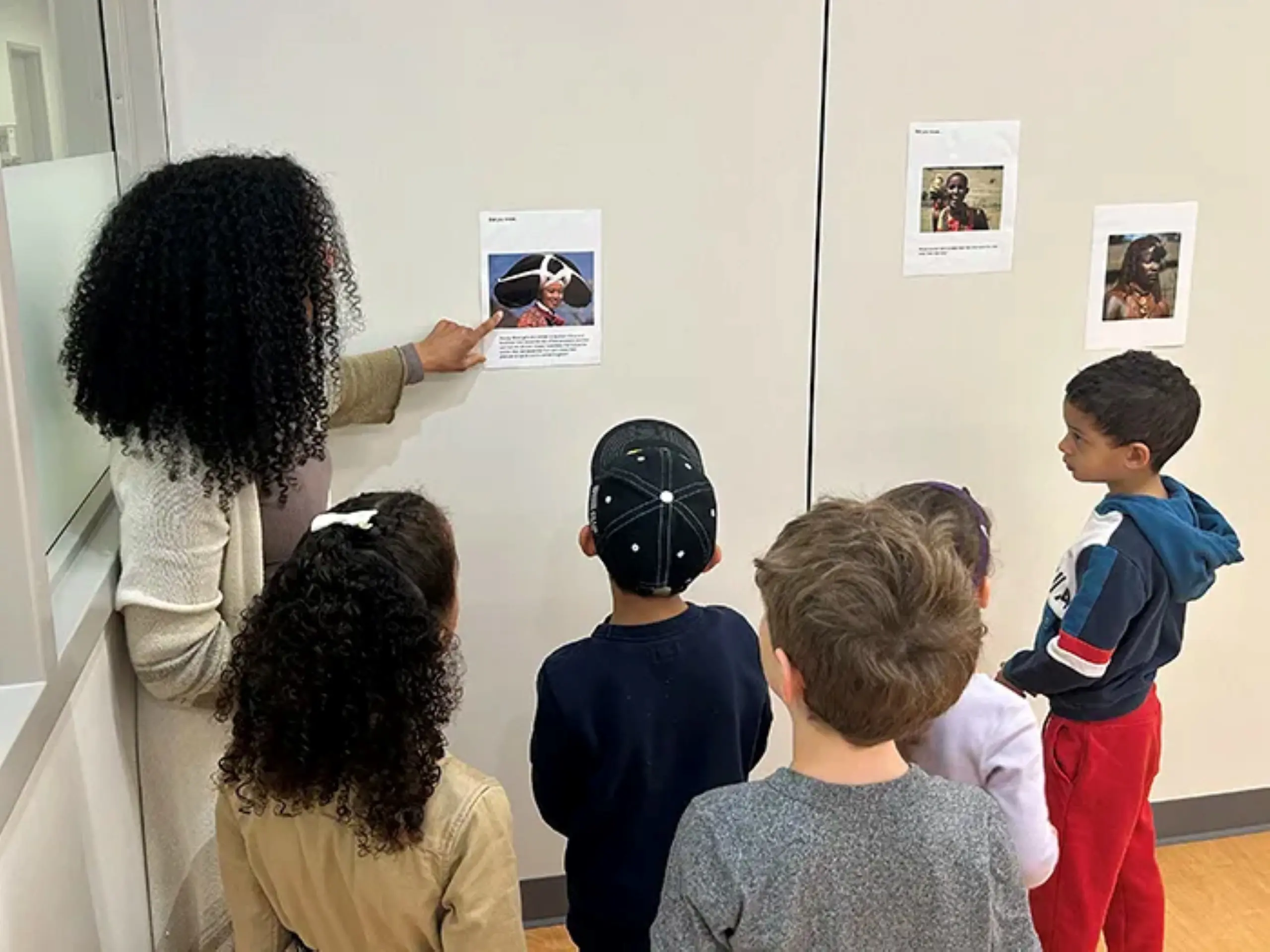 Teacher reading out a poster to students