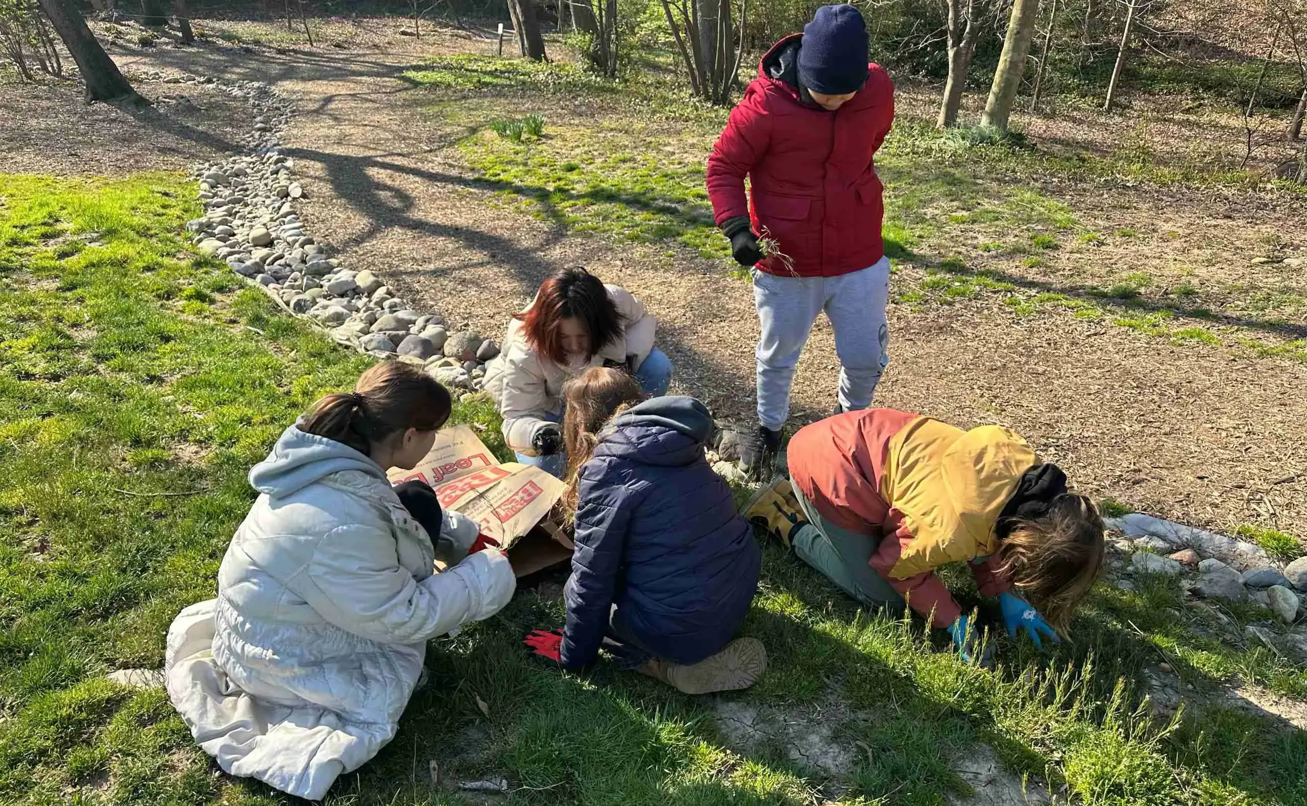 Students kneeling on grass