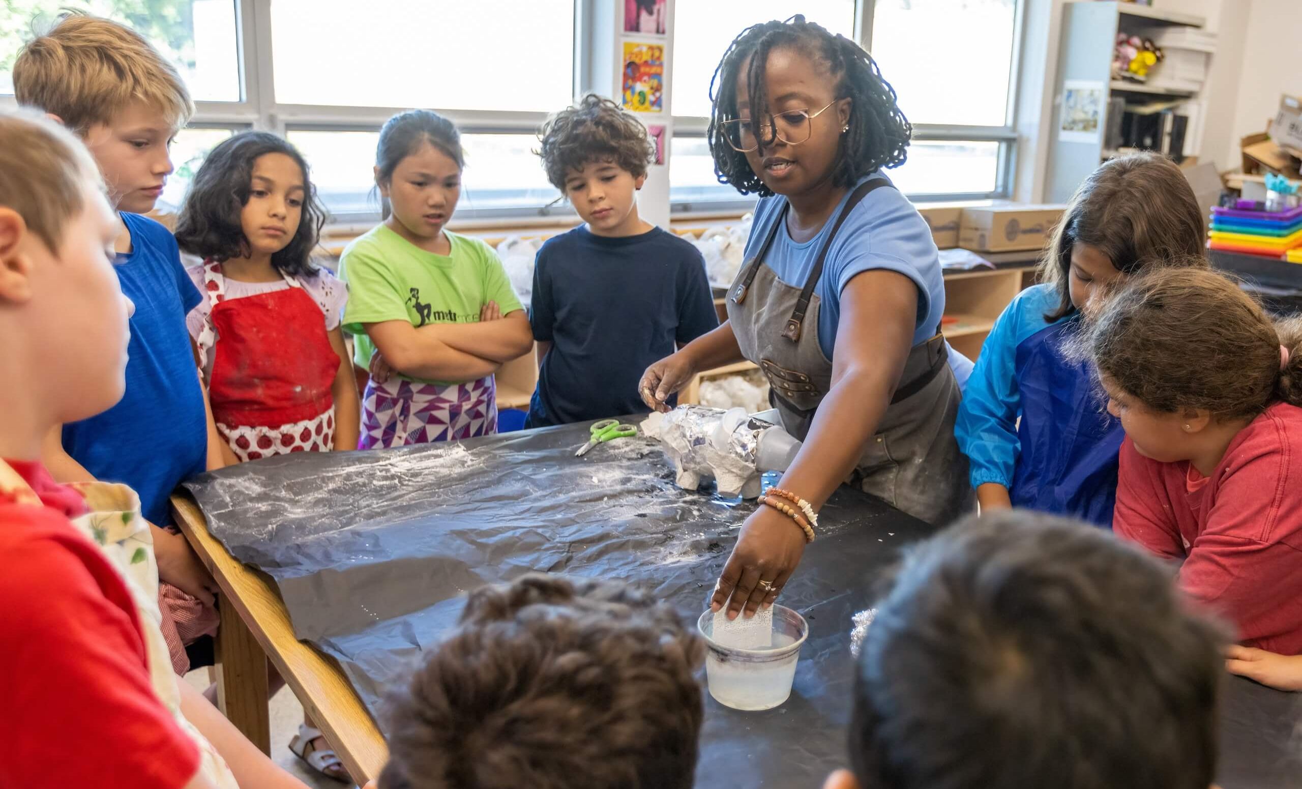 Teacher showing a demonstration to children