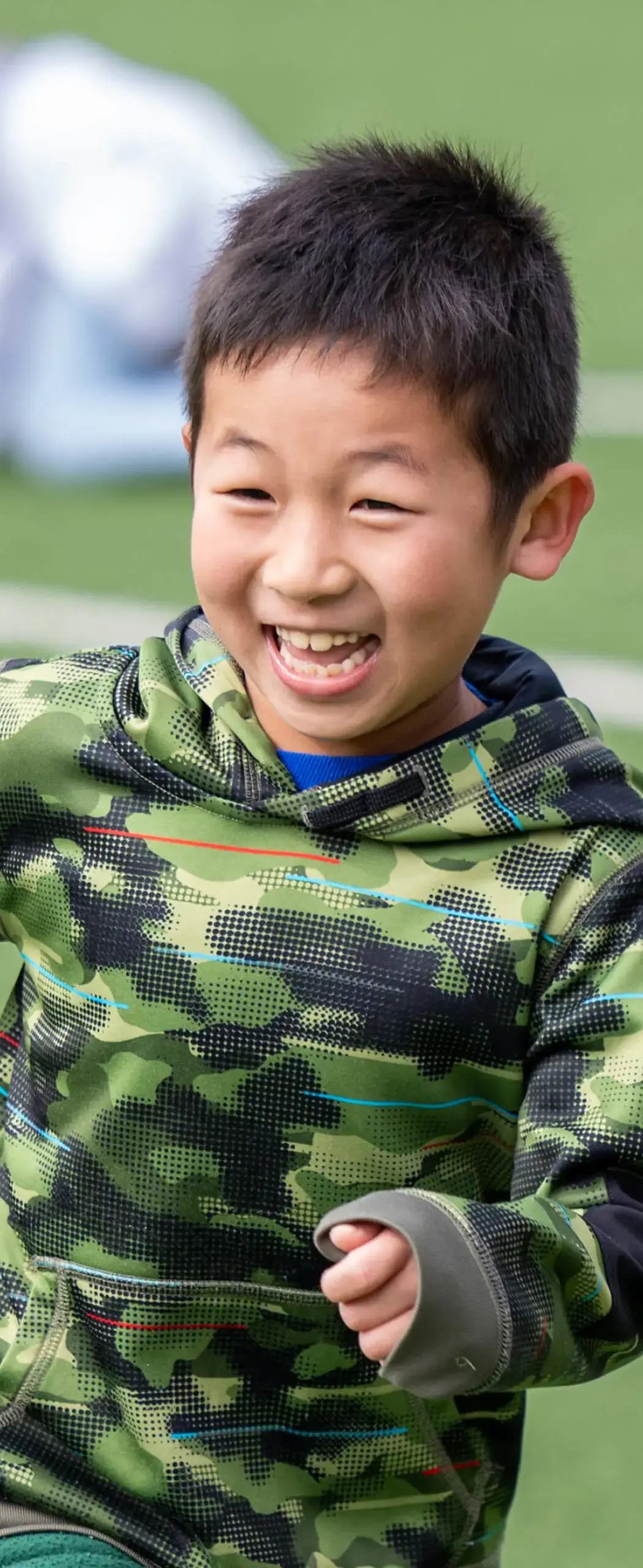 little boy running on a field