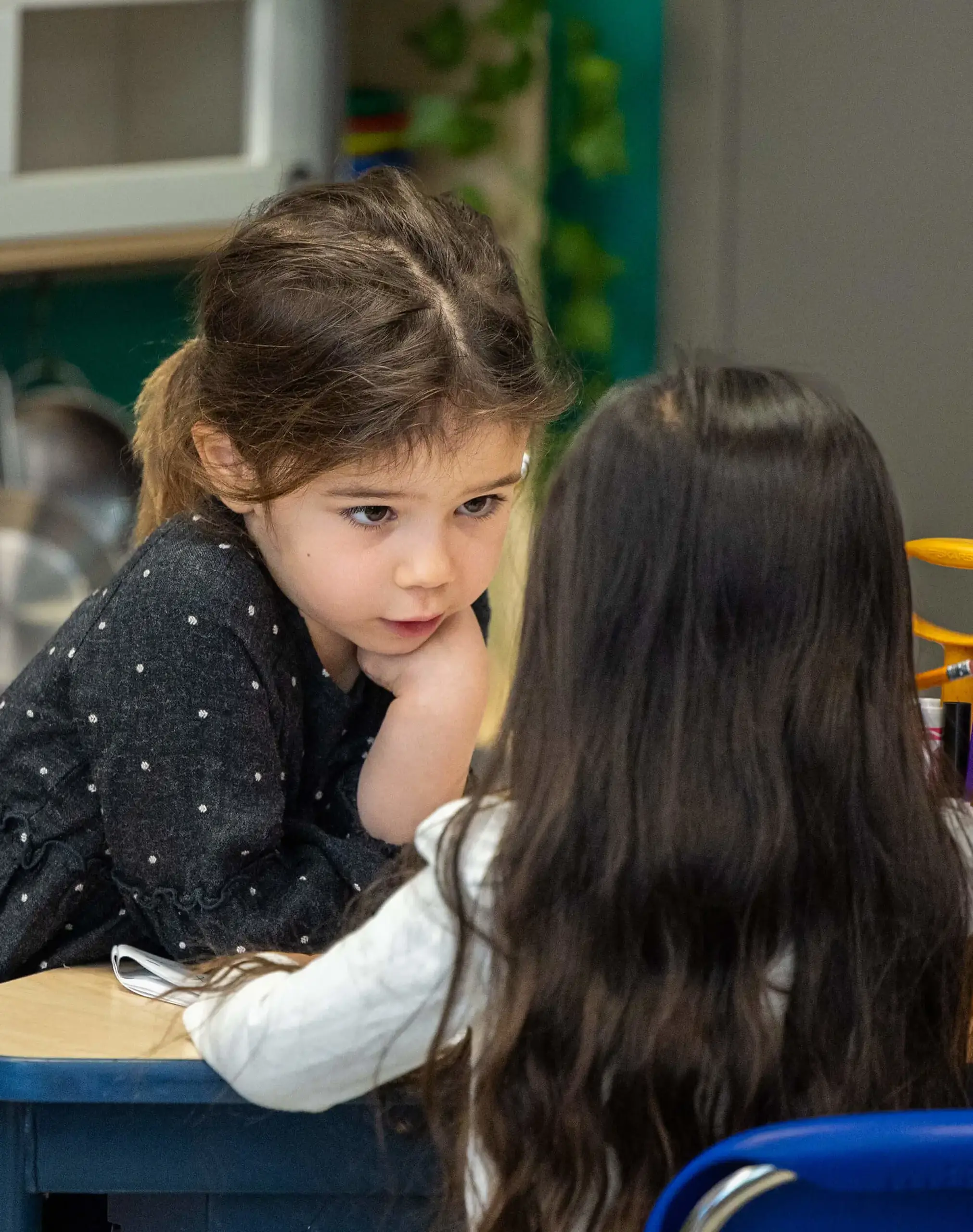 two little girls in a classroom