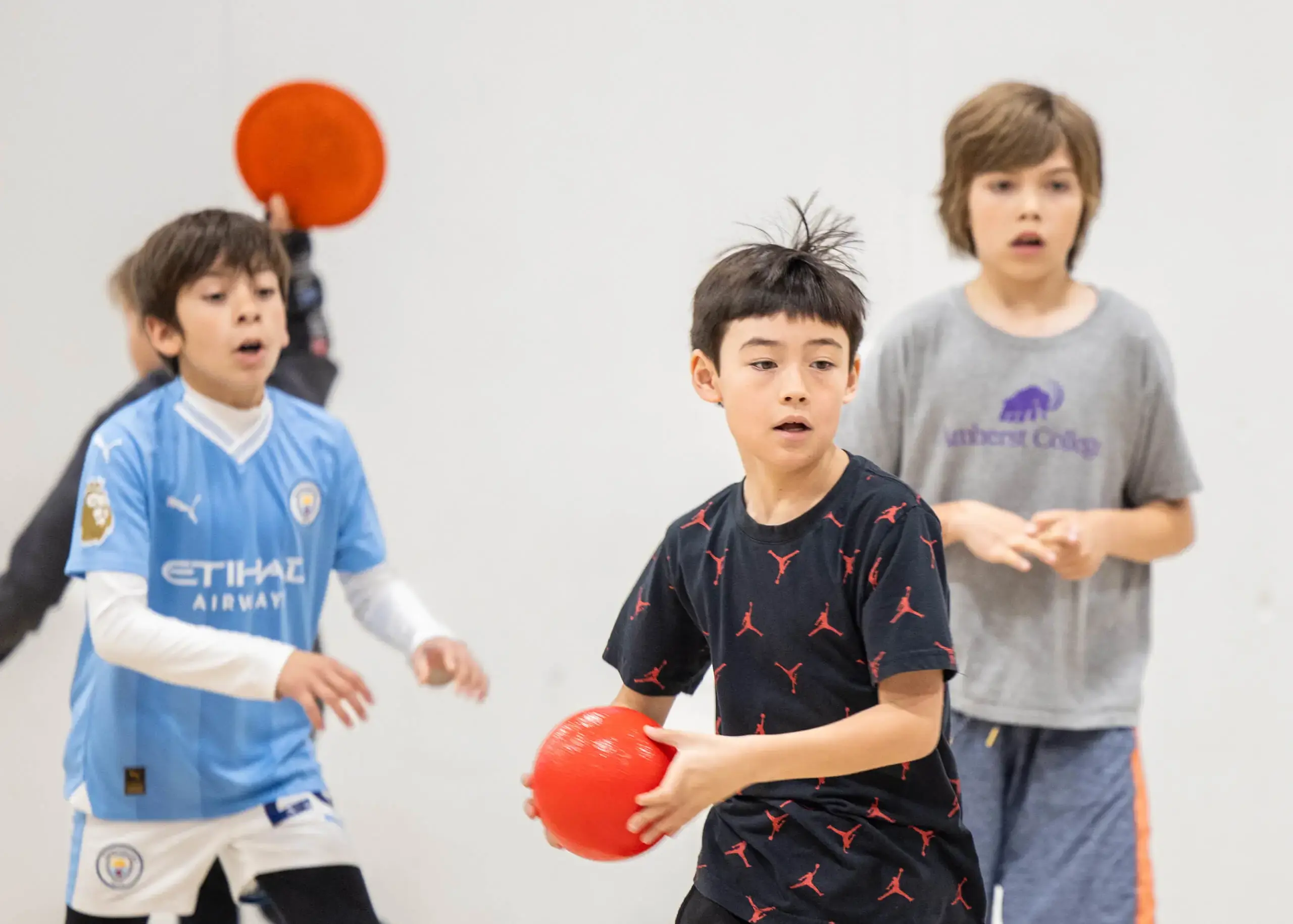 boys throwing balls in class