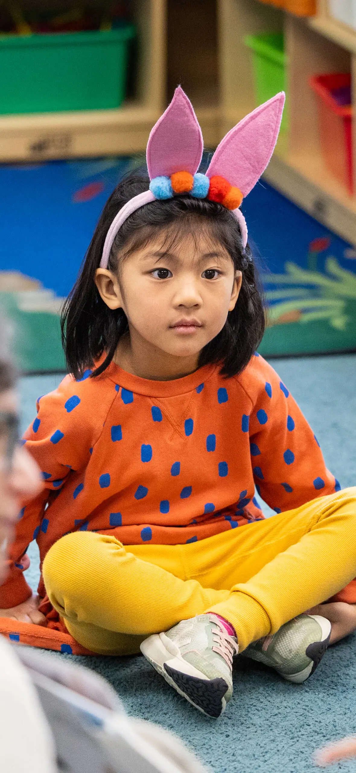 Girl cross-legged on floor