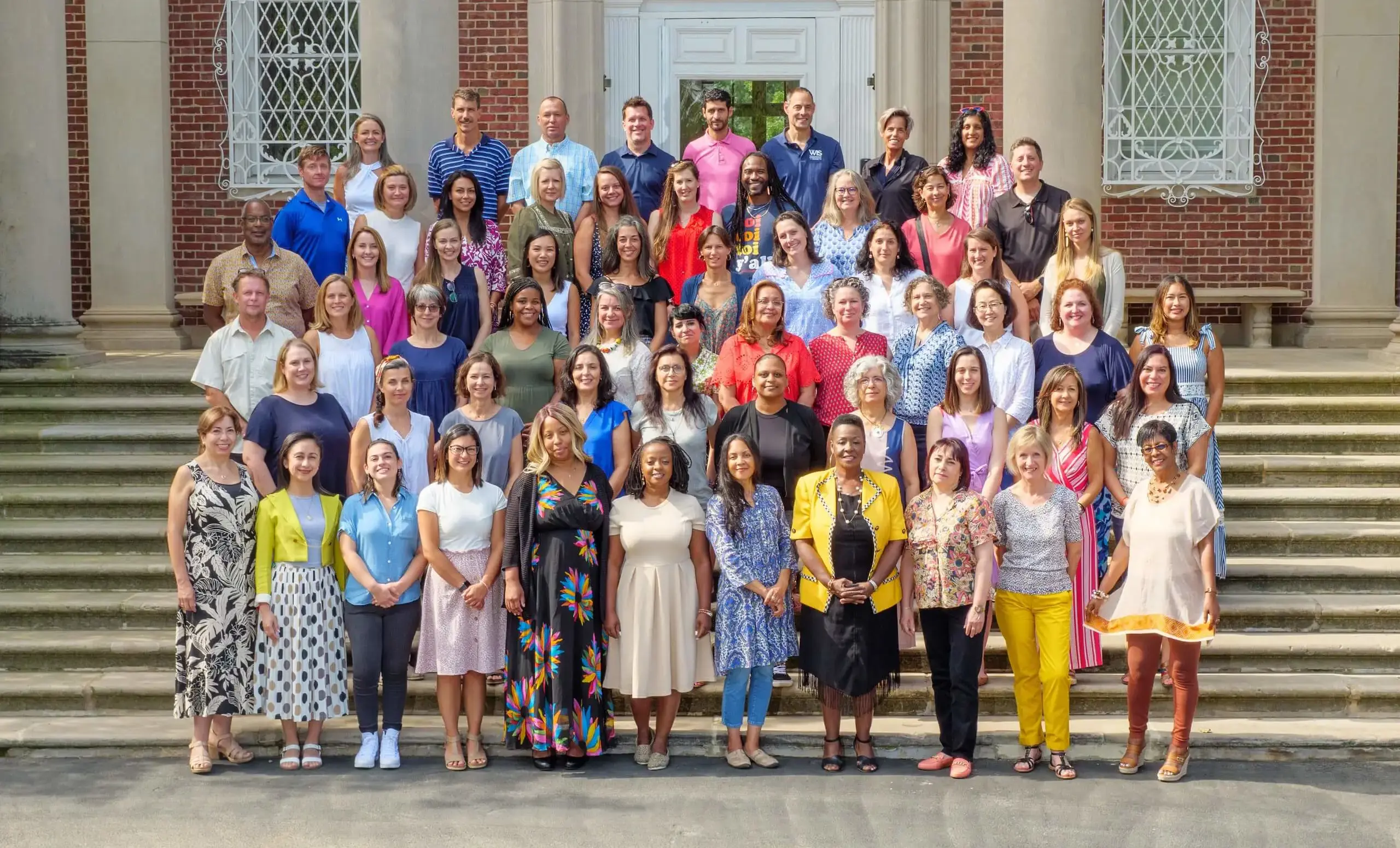 Primary school faculty standing on stairs