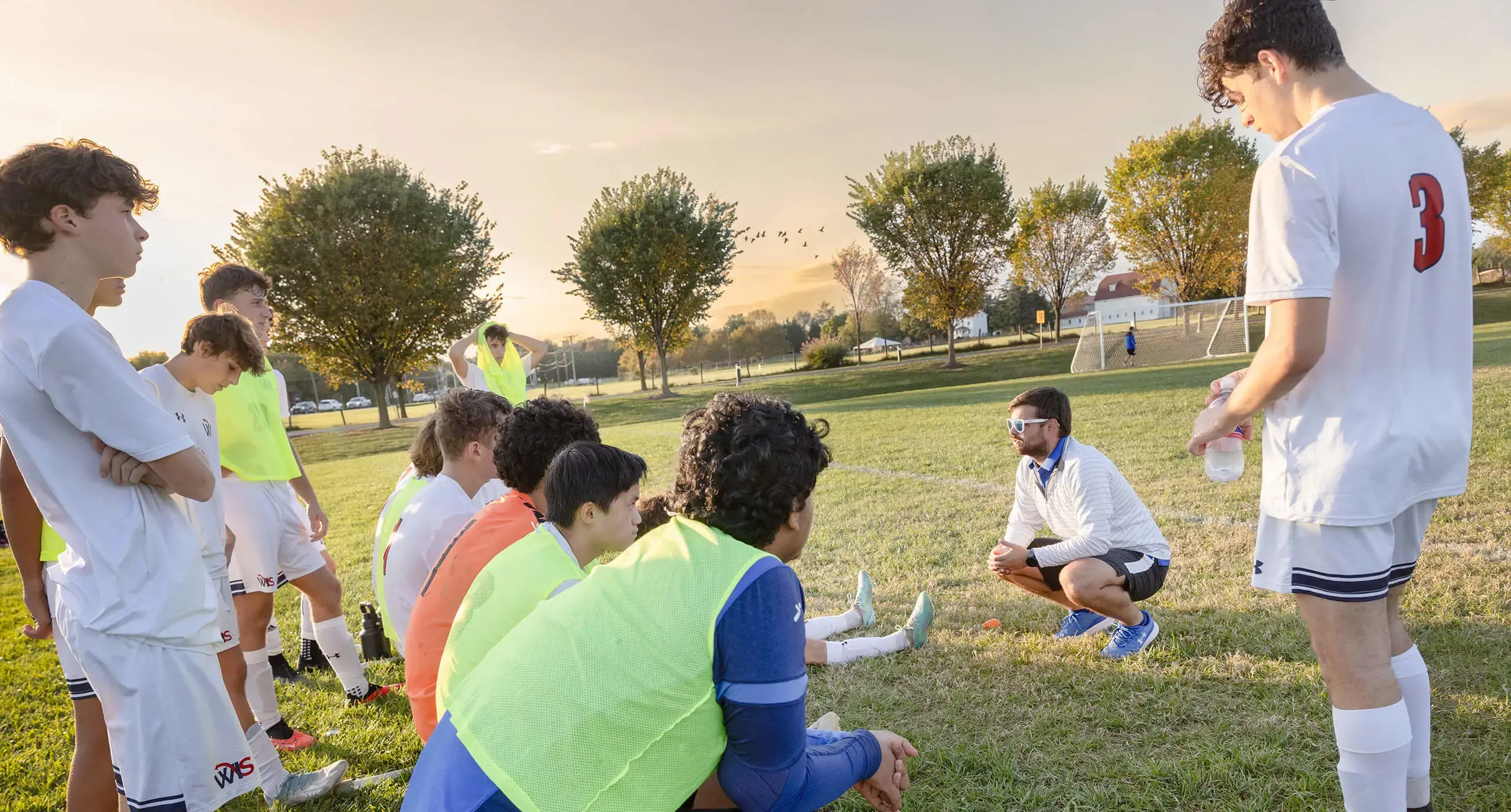 boys soccer team listening to coach