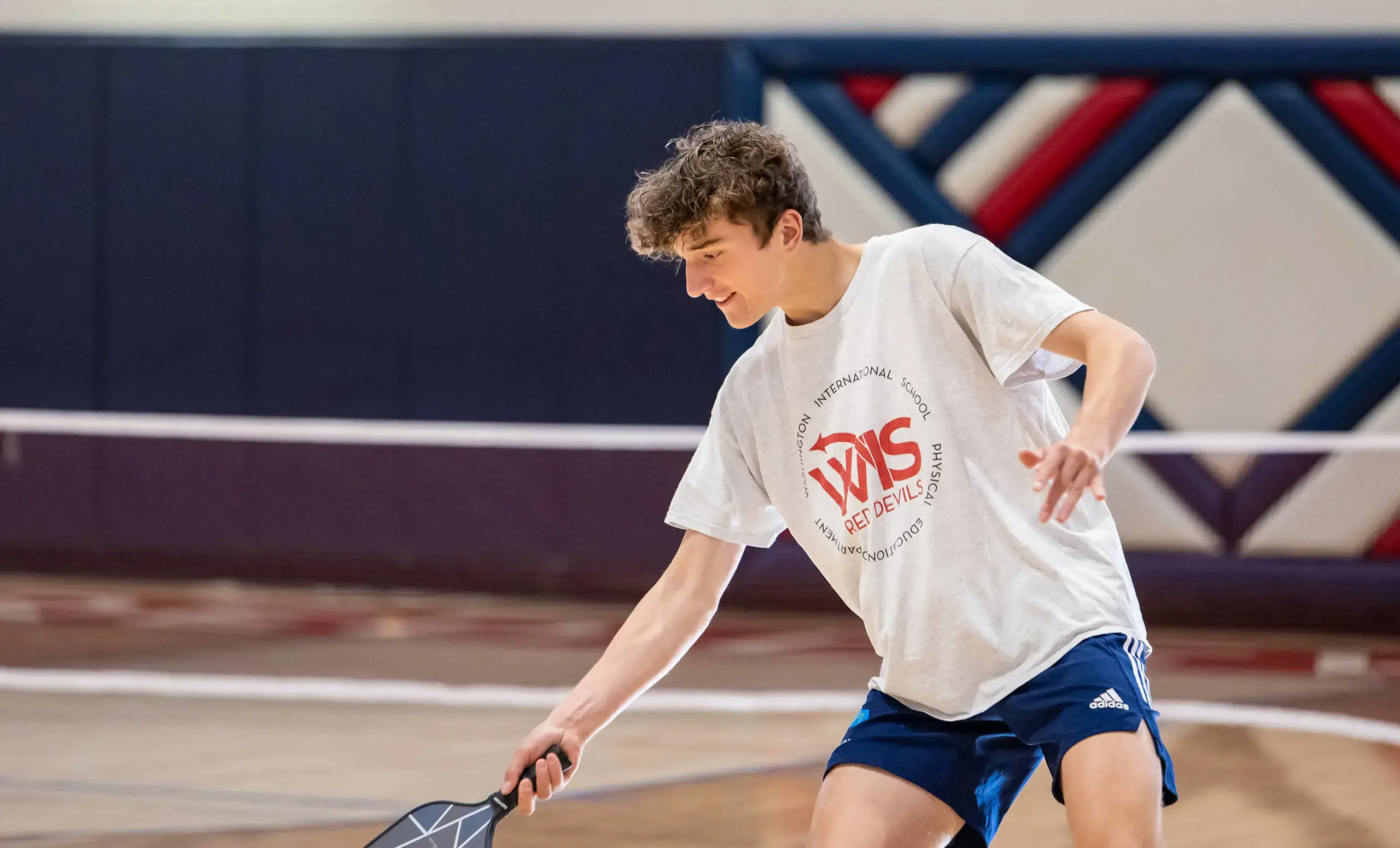 Upper School boy playing pickleball