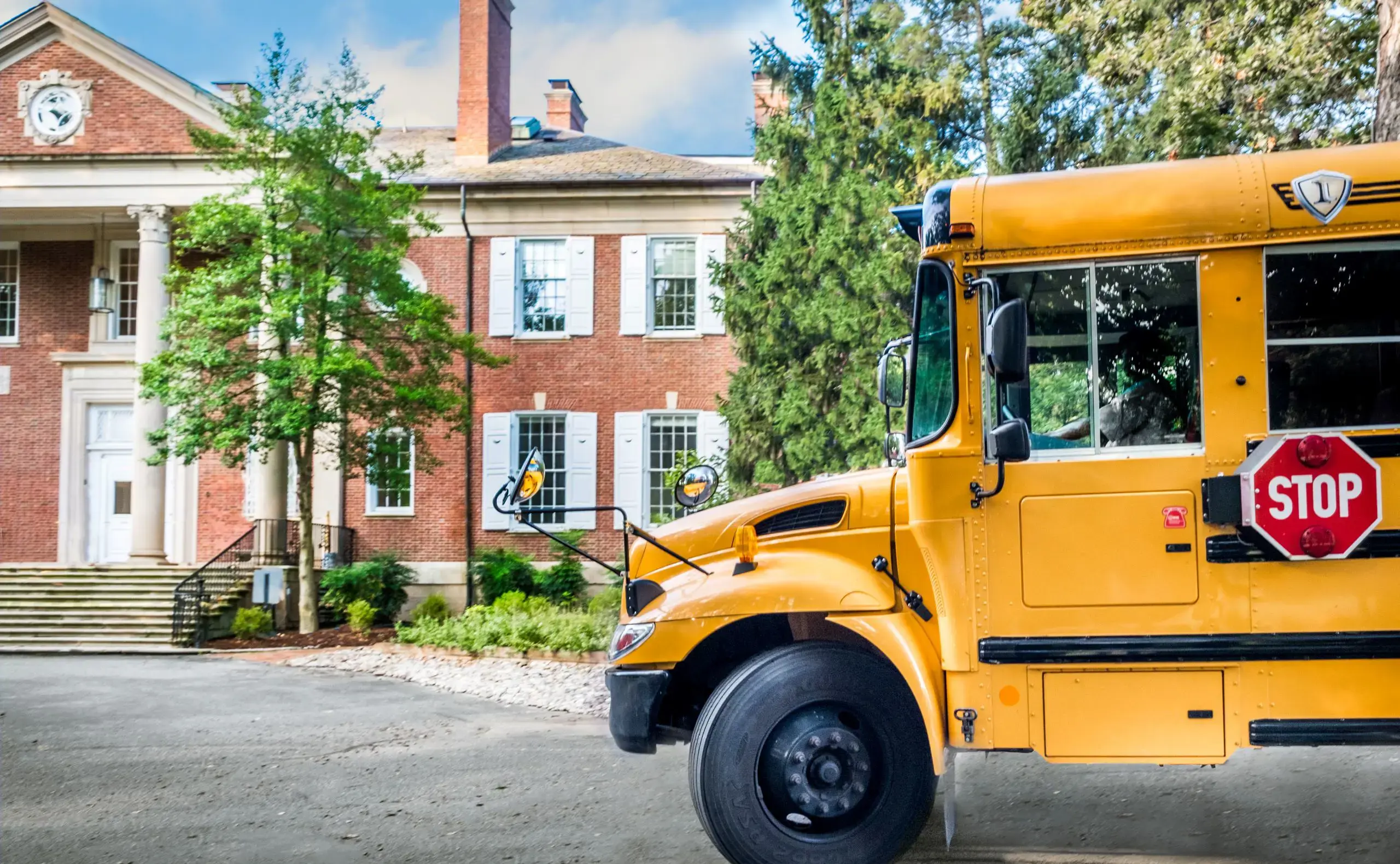 Bus in front of mansion