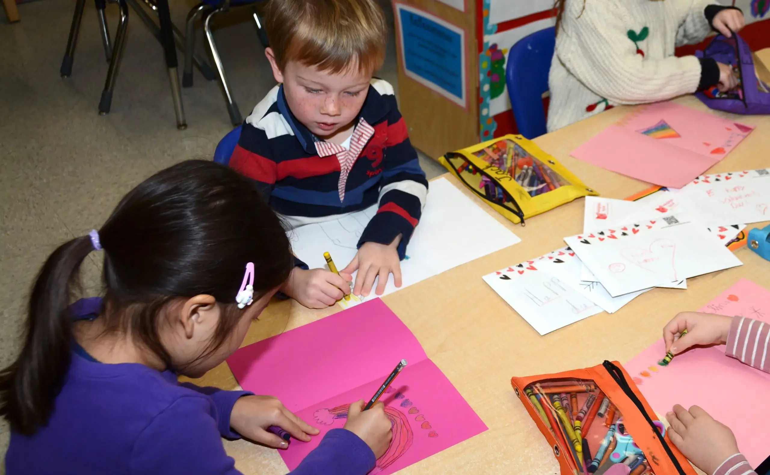 Younger students making valentines cards