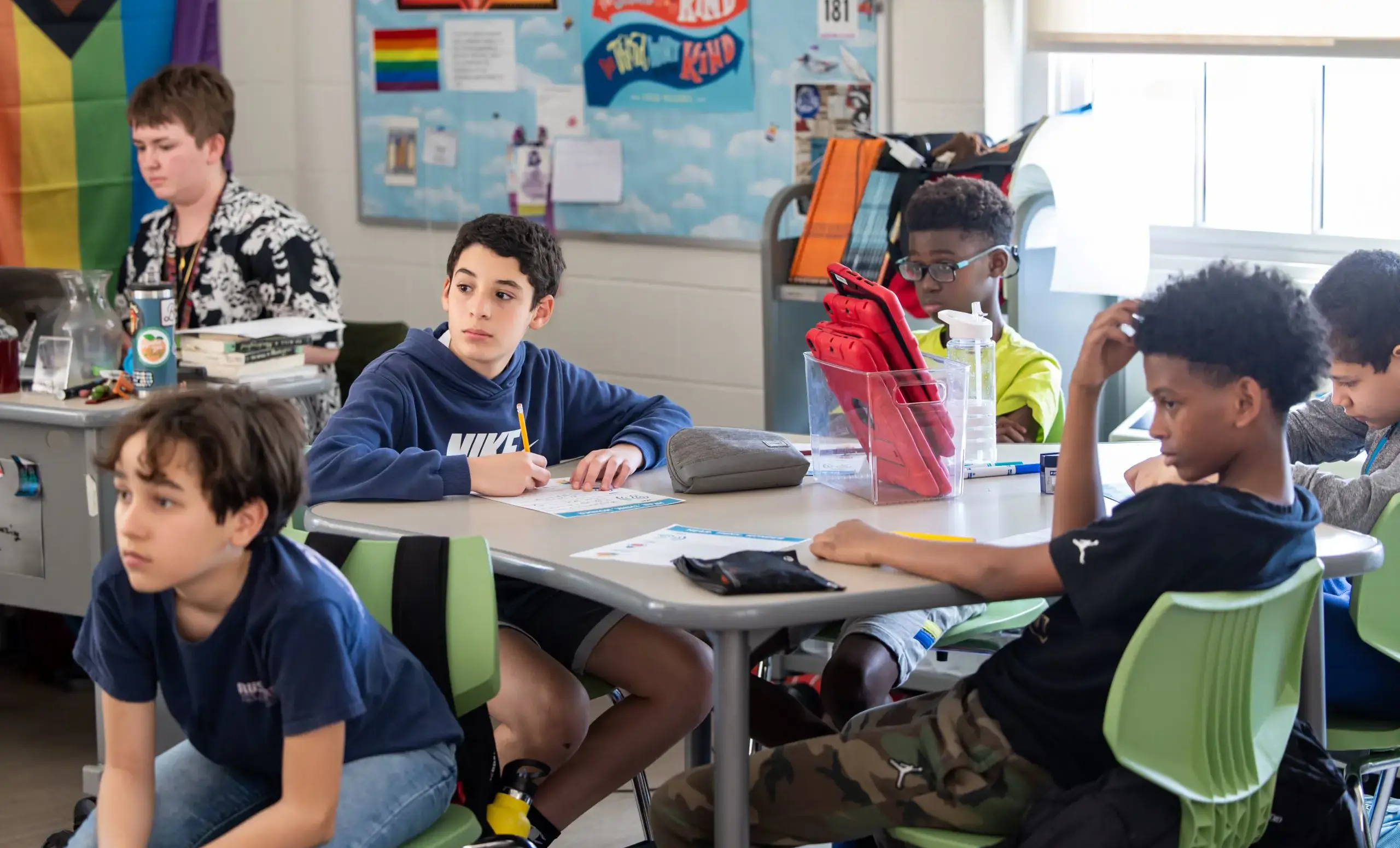 several boys and a teacher in a classroom