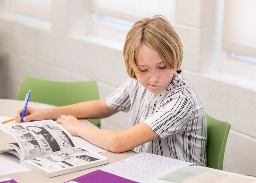 Student at a desk with papers