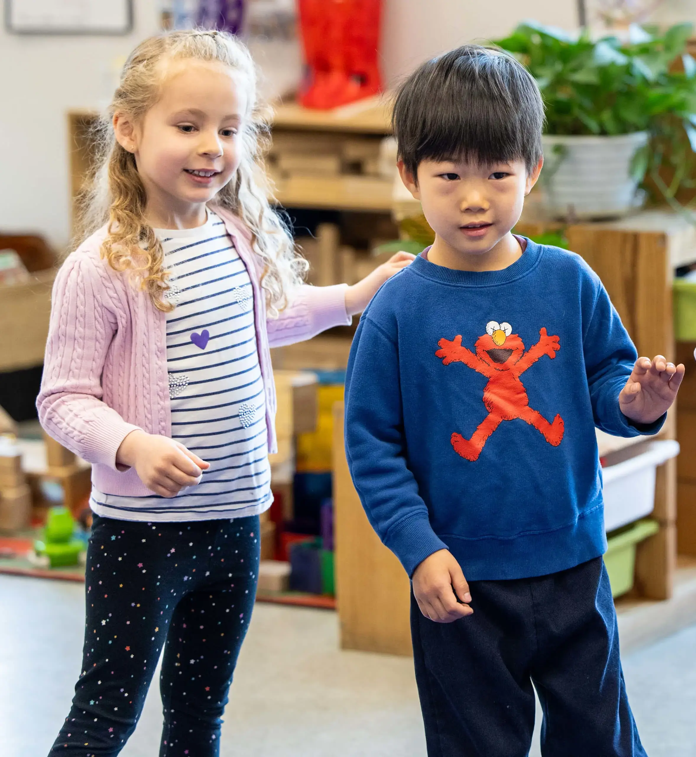 three cute children in a classroom