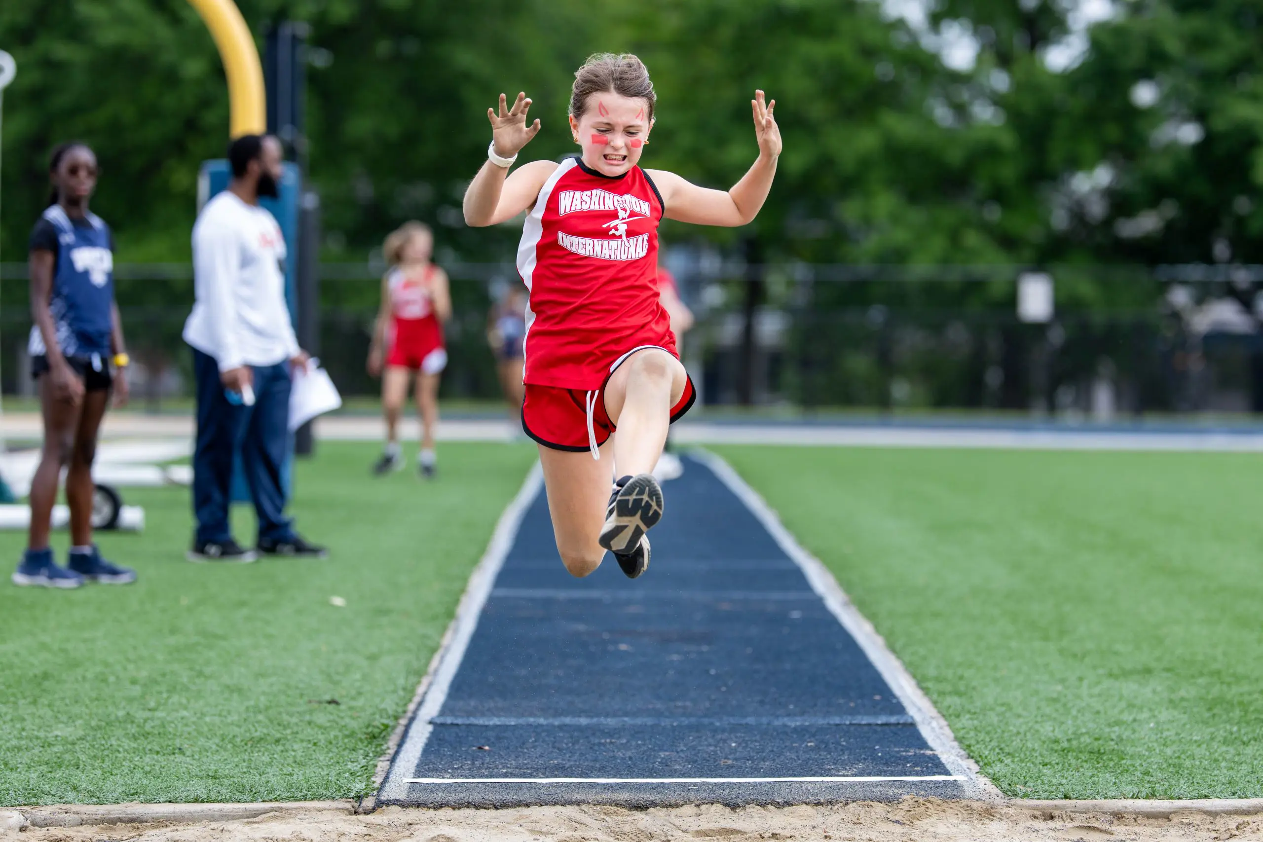 Student performing long jump