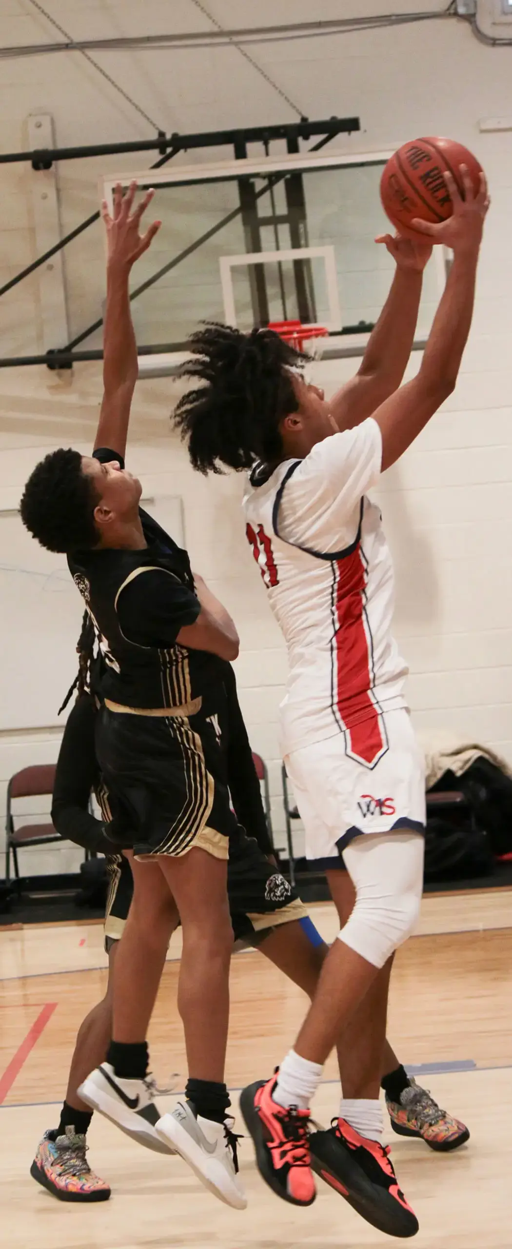 boy taking a shot at a basketball hoop