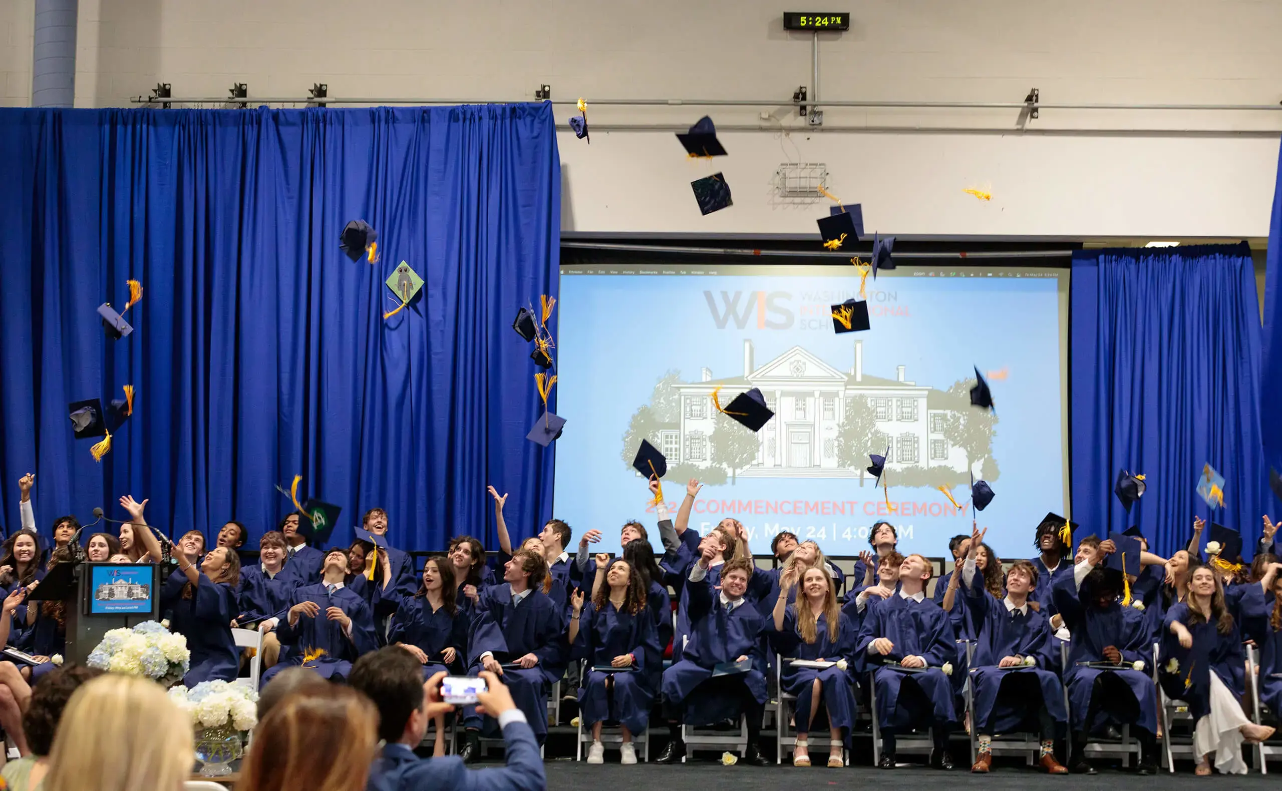 Students throw their caps into the air at graduation